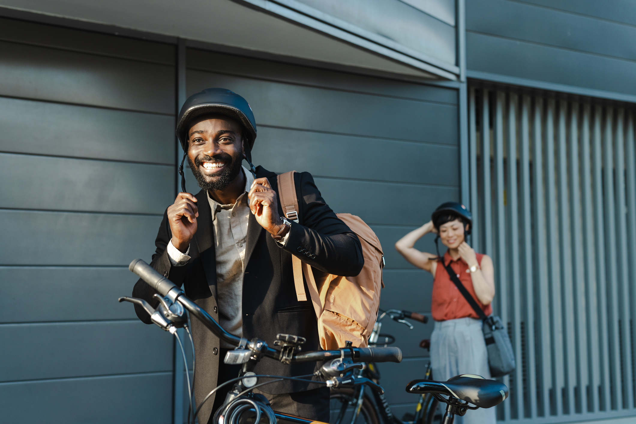 smiling businessman with bicycle commuting to work in the city
